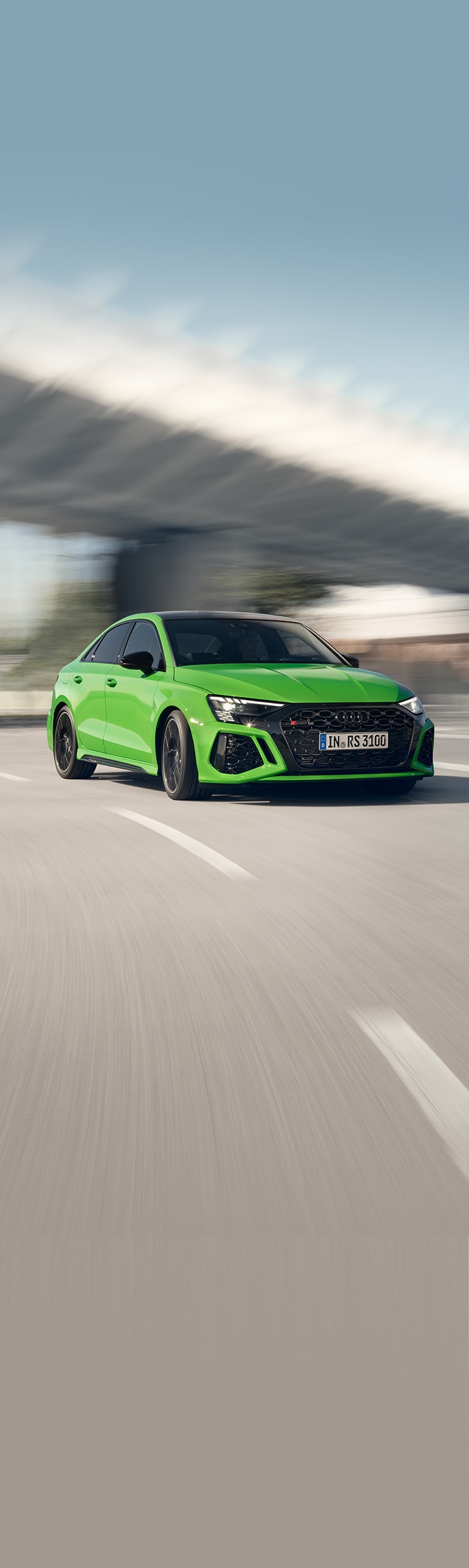 Audi RS 3 sedan on the road in side view 