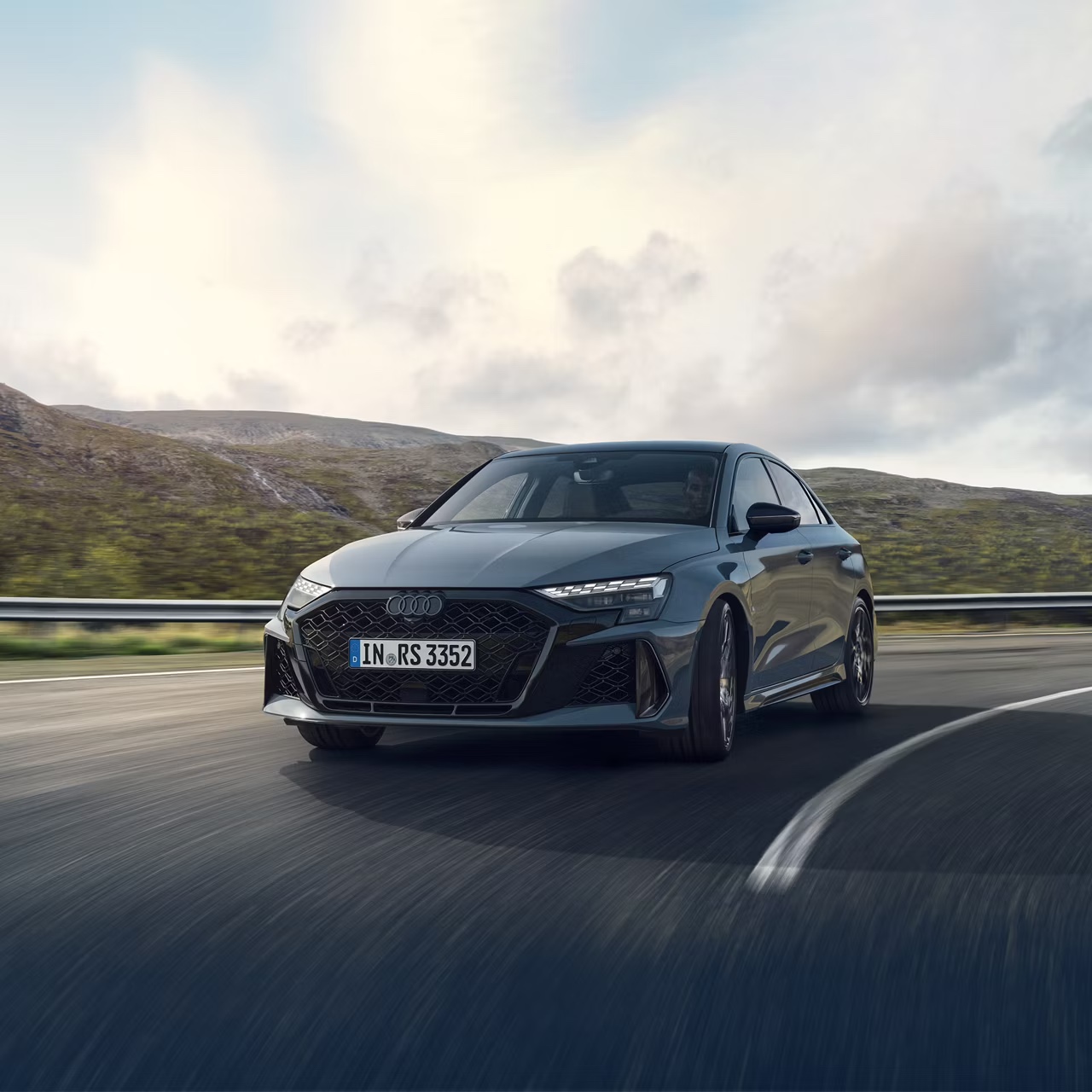 Grey Audi RS 3 Saloon driving on the street.